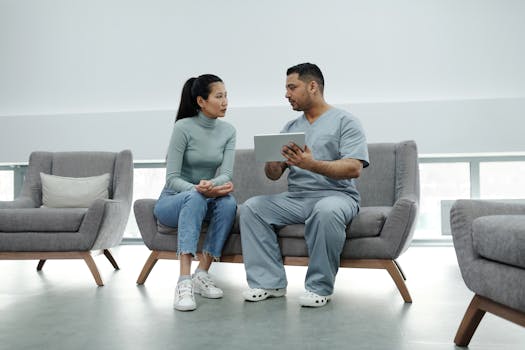 healthcare provider using a tablet to communicate with a patient